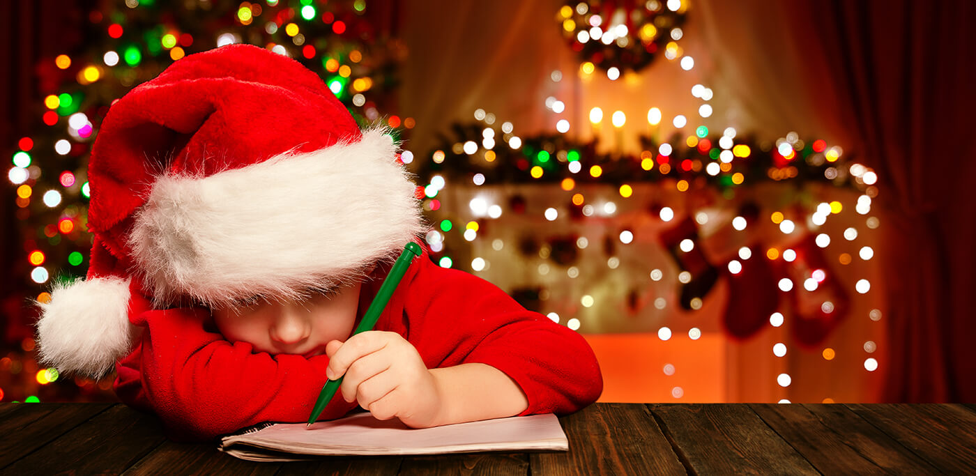 Child writing a Christmas wish list