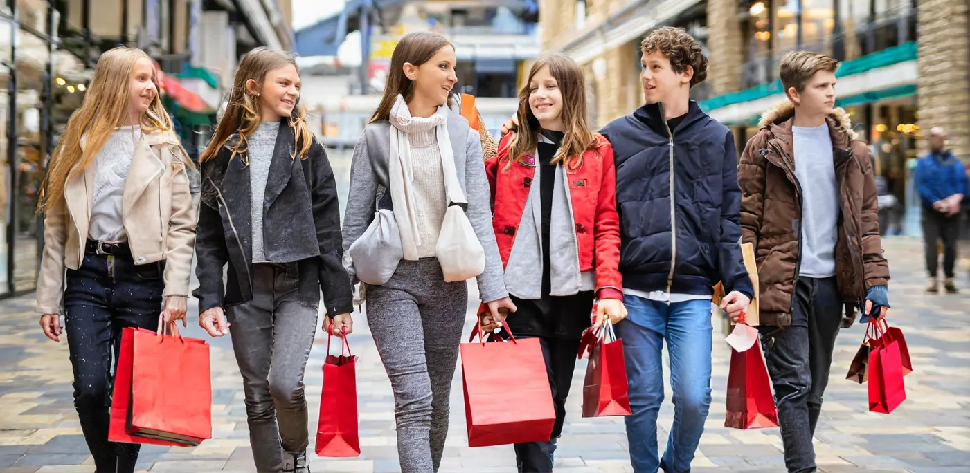 Group of Gen Z boys and girls going shopping