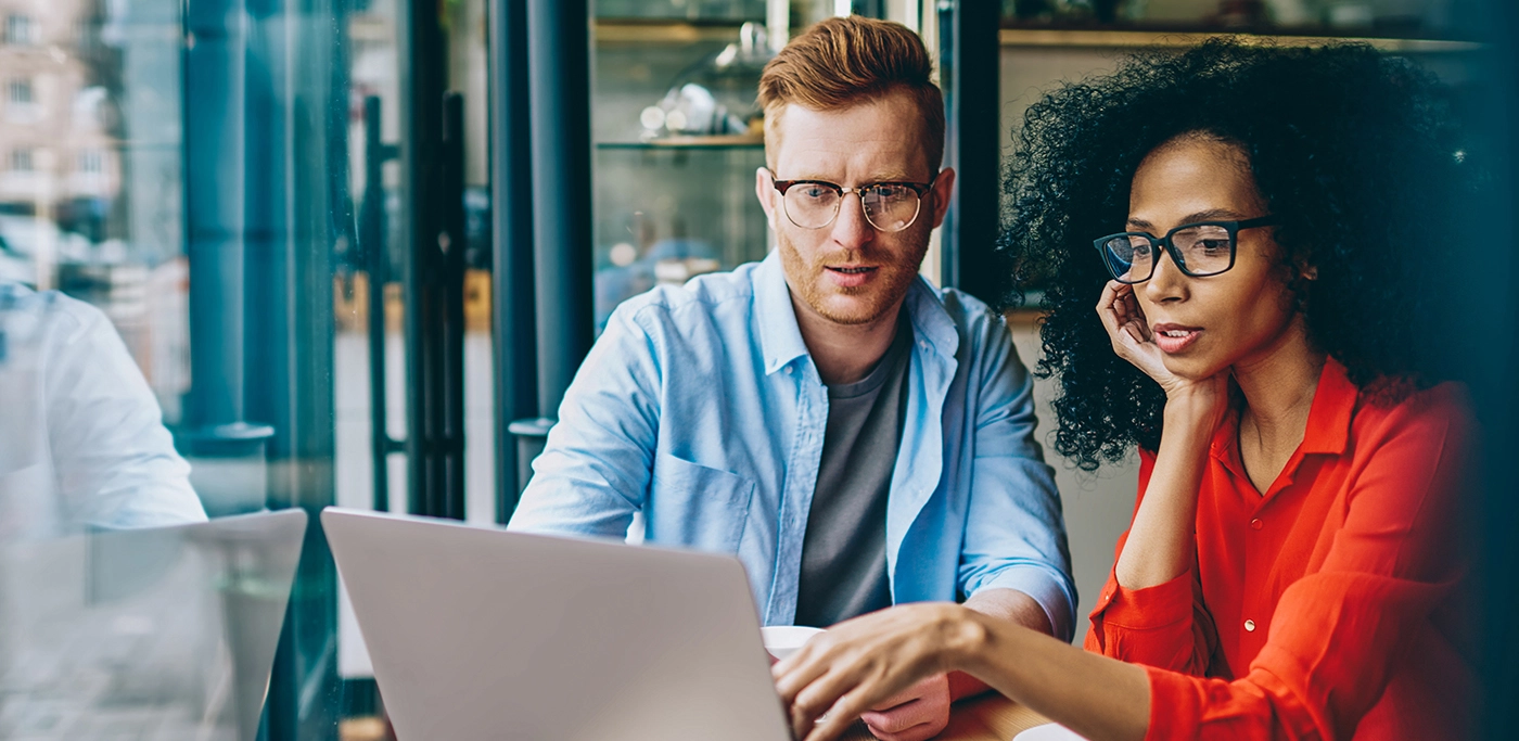 Man and women working together on their laptop