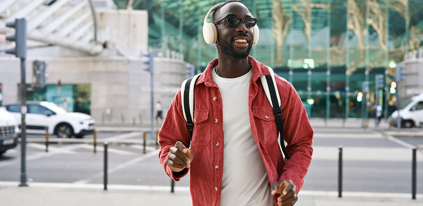 Student wearing headphones on way to uni