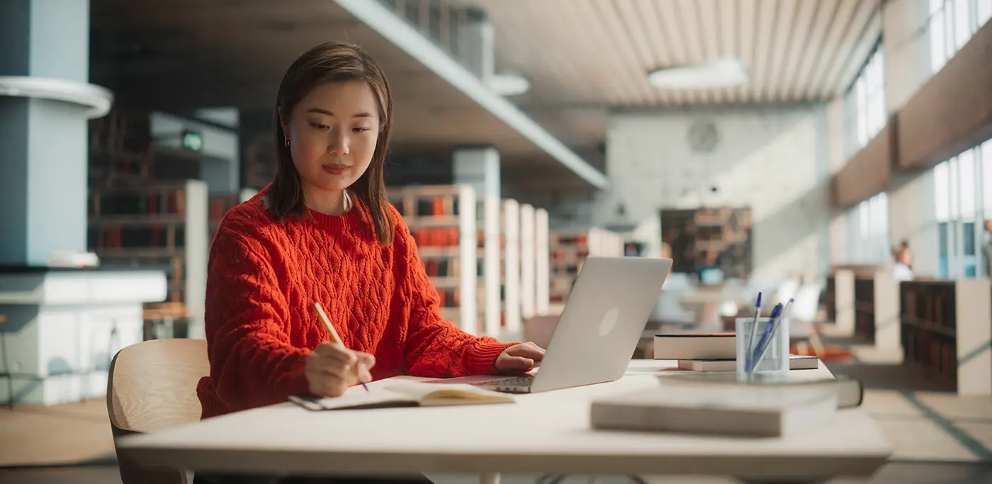 Student in the library on laptop