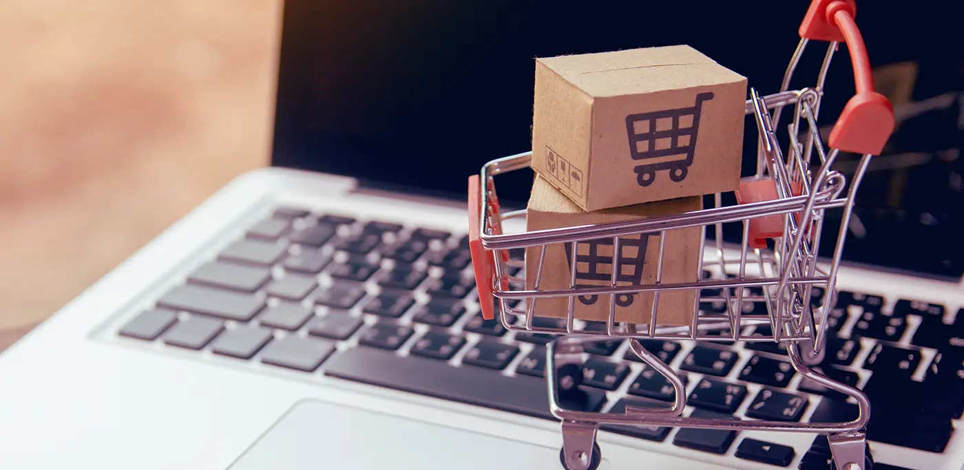 Little shopping cart on top of a laptop keyboard