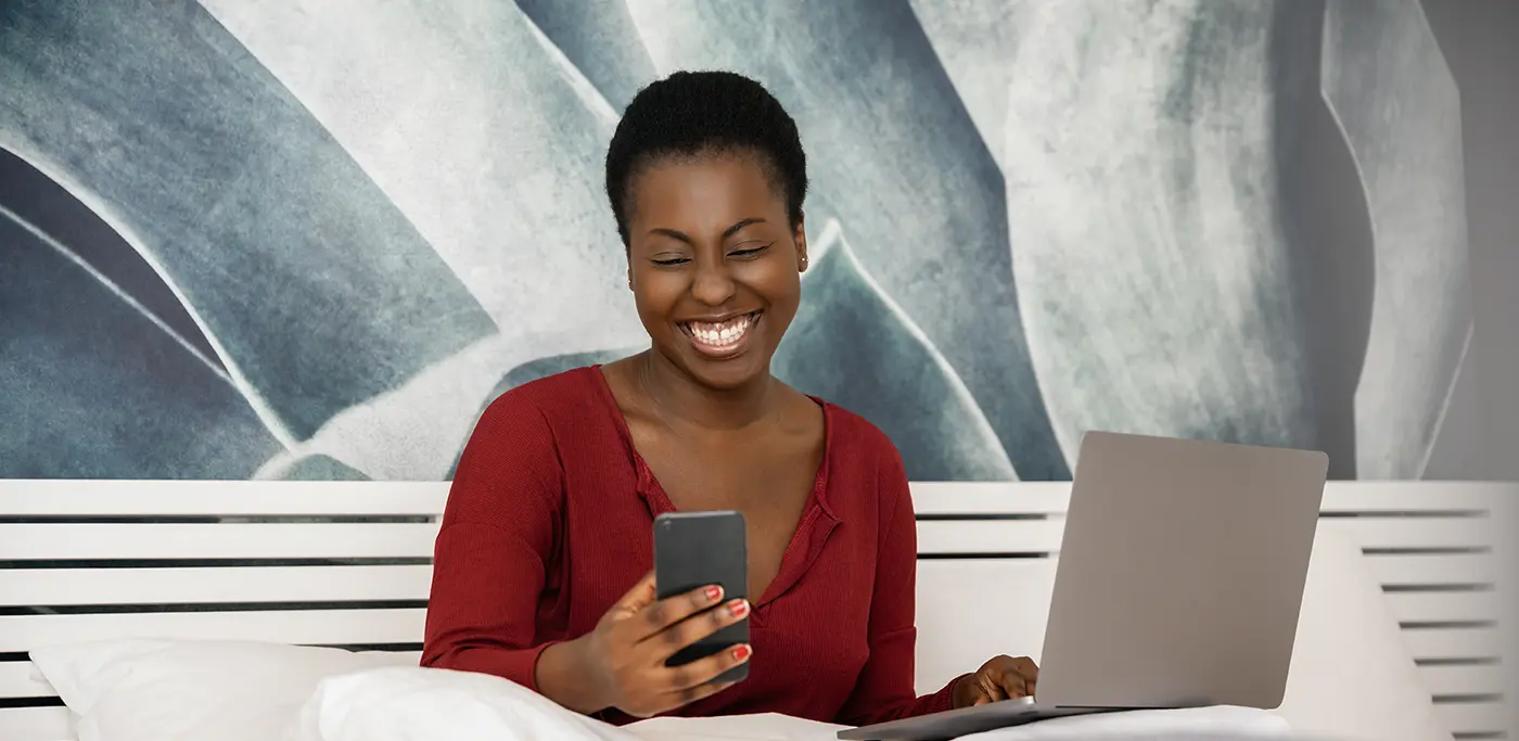 Black Women on laptop and phone at same time