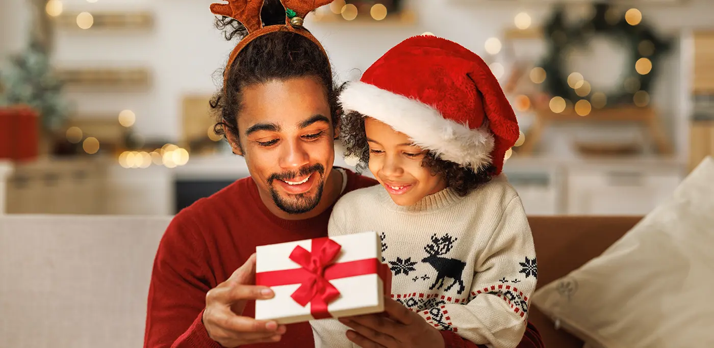 Dad and son opening up a Christmas present