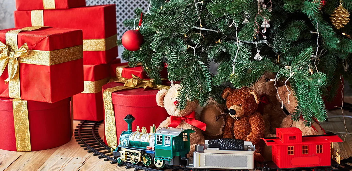 Presents and toy train under Christmas tree