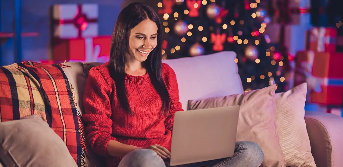 Women sat on sofa browsing on her laptop