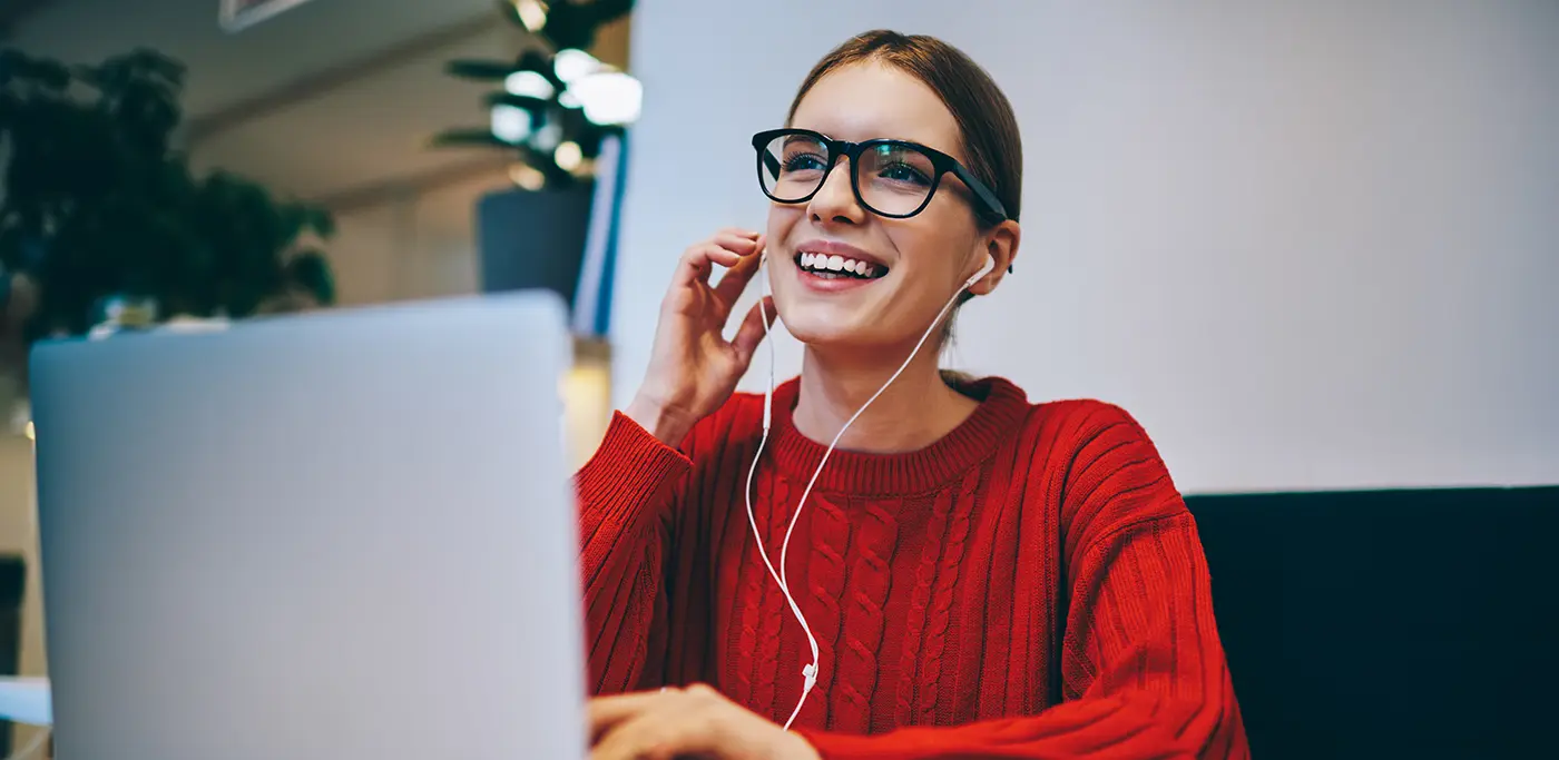 Women in red jumper at work on her laptop